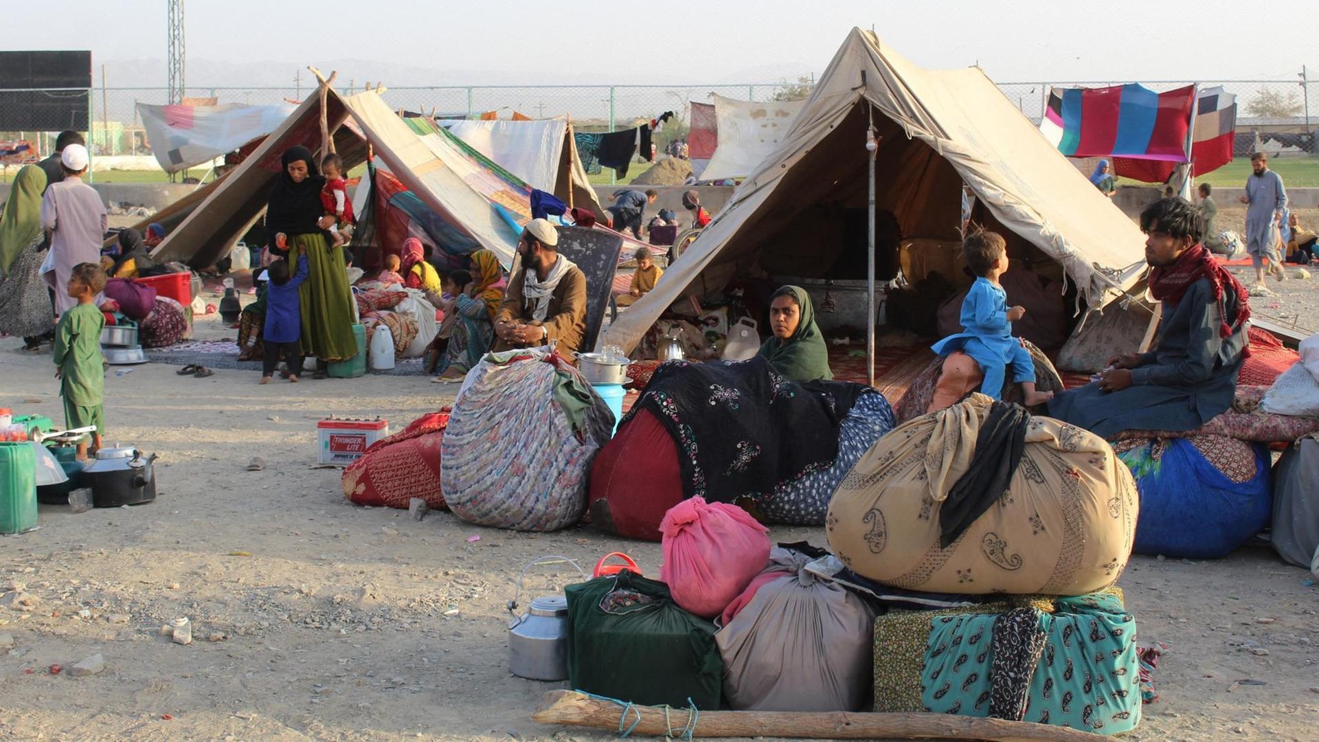 Aus Afghanistan geflüchtete Menschen sitzen in einem Zeltlager in der pakistanischen Grenzstadt Chaman.
