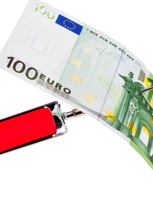 Injektionsspritze und -nadel mit aufgespiesstem 100-Euro-Schein
