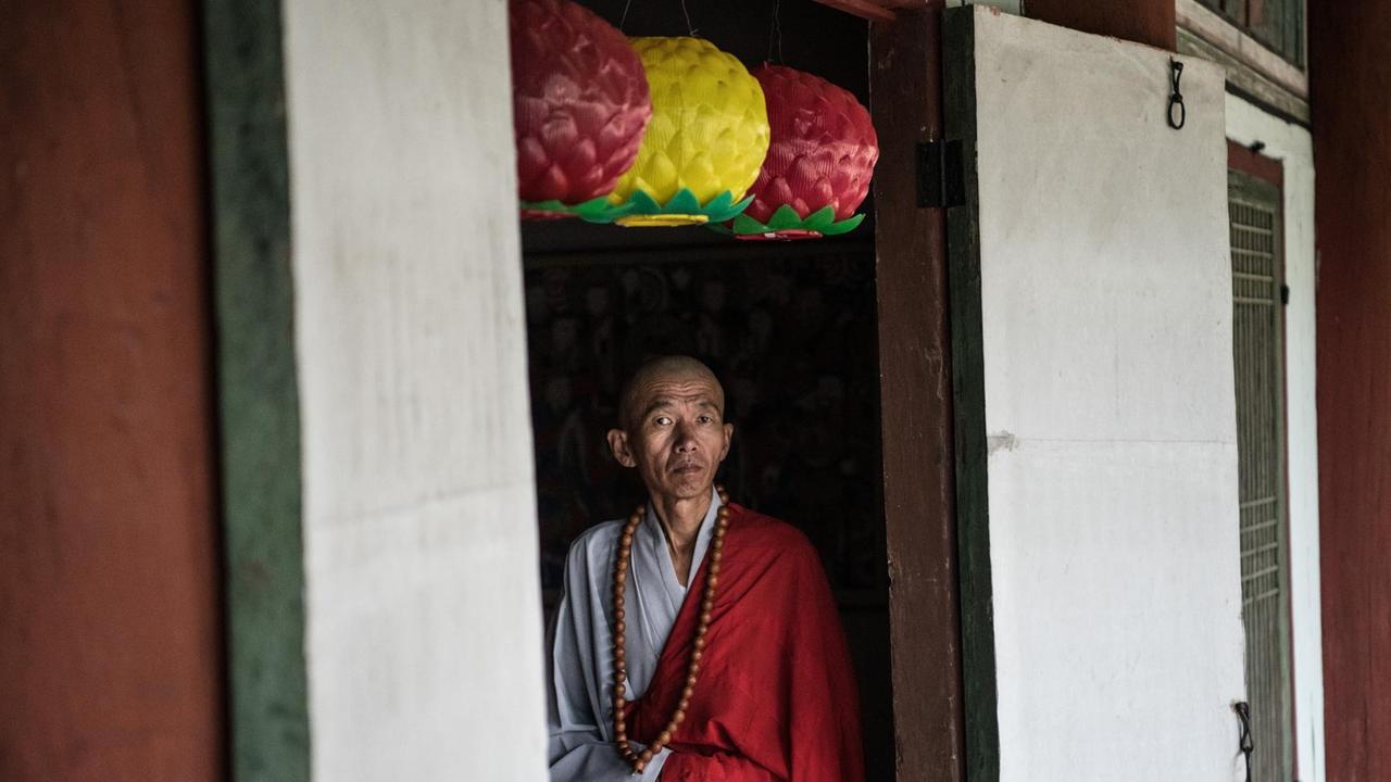 Ein buddhistischer Mönch steht in einer Tür, während er darauf wartet, ausländische Touristen zu begrüßen, die am 20. August 2018 den Pohyon-Tempel in Myohyang, Nordkorea, besuchen.