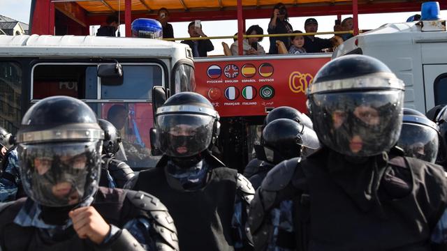 Eine Gruppe maskierter russischer Polizisten blockiert einen Bereich während einer Demo für faire Wahlen in der Moskauer Innenstadt am 3. August 2019