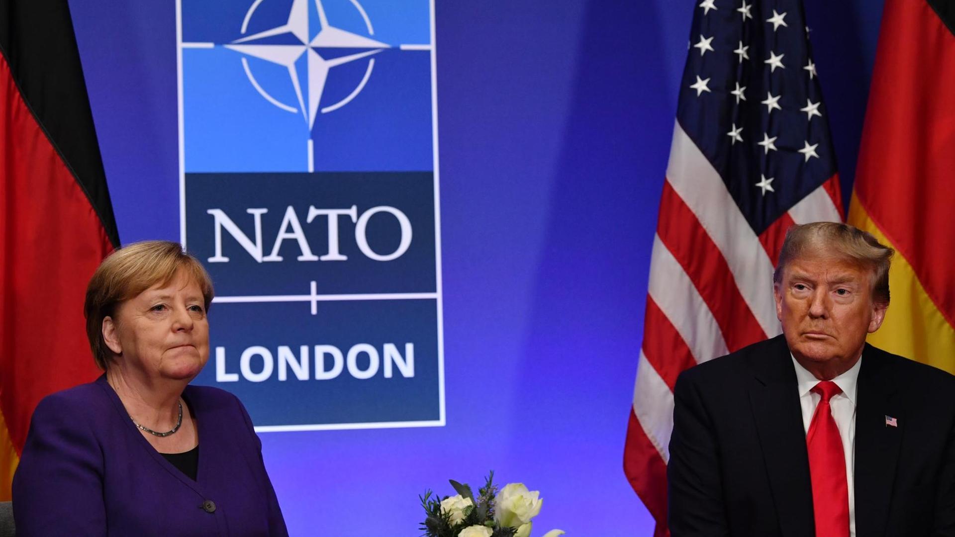 German Chancellor Angela Merkel (L) and US President Donald Trump hold a bilateral meeting on the sidelines of the NATO summit at the Grove hotel in Watford, northeast of London on December 4, 2019. (Photo by Nicholas Kamm / AFP) German Chancellor Angela Merkel (L) and US President Donald Trump hold a bilateral meeting on the sidelines of the NATO summit at the Grove hotel in Watford, northeast of London on December 4, 2019. (Photo by Nicholas Kamm / AFP)