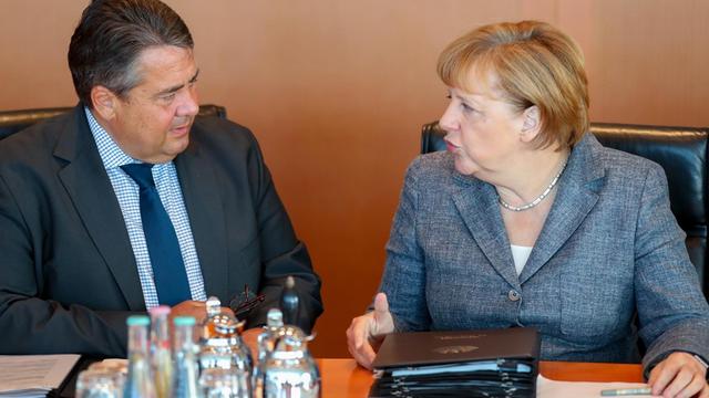 Bundeskanzlerin Angela Merkel (CDU) und Bundeswirtschaftsminister Sigmar Gabriel (SPD) unterhalten sich in der Sitzung des Bundeskabinetts.