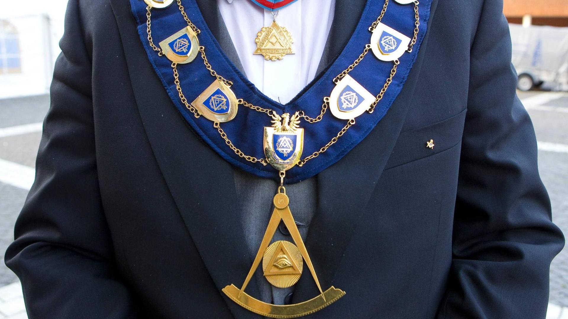 Detailansicht des goldenen Ordensschmucks eines Großmeisters der Freimaurer mit Freimaurersymbolen. Detailansicht des goldenen Ordensschmucks eines Großmeisters der Freimaurer mit Freimaurersymbolen.