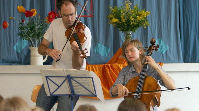 Die Cellistin Tanja Tetzlaff (r) und der Geiger Florian Donderer spielen in einer Bremer Grundschule.
