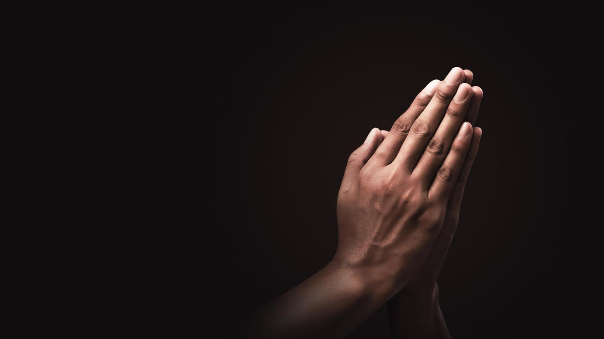 Praying hands with faith in religion and belief in God on dark background. Power of hope or love and devotion. Namaste or Namaskar hands gesture. Prayer position. Praying hands with faith in religion and belief in God on dark background. Power of hope or love and devotion. Namaste or Namaskar hands gesture. Prayer position.