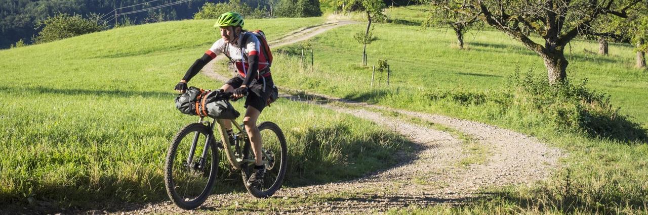 Mountain Biker auf einer unbefestigten Straße Mountain Biker auf einer unbefestigten Straße