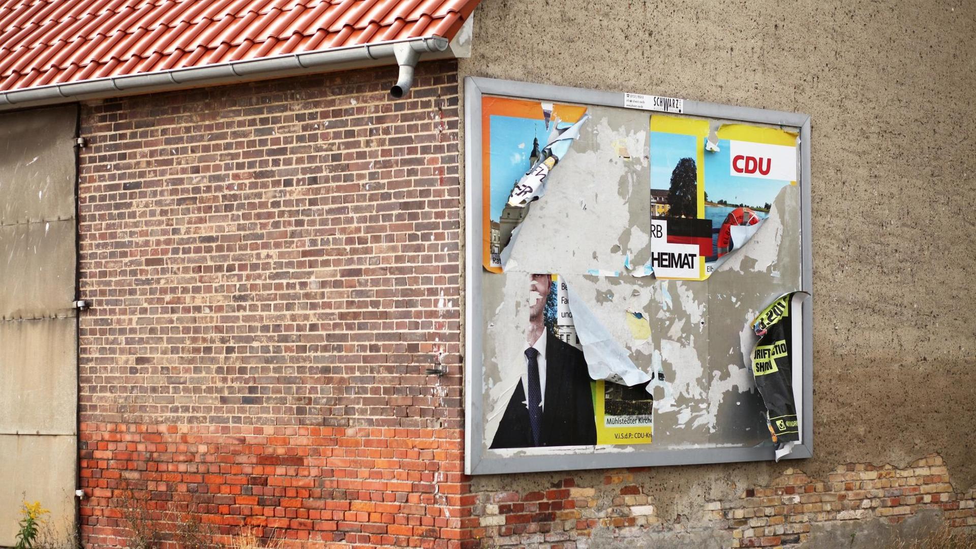 Ein abgerissenes Wahlplakat der CDU hängt an der Wand eines leerstehenden Hauses im Stadttreil Griesen. Auf den verbliebenen Fetzen sind noch der Parteiname und das Wort "Heimat" zu lesen. Ein abgerissenes Wahlplakat der CDU hängt an der Wand eines leerstehenden Hauses im Stadttreil Griesen. Auf den verbliebenen Fetzen sind noch der Parteiname und das Wort "Heimat" zu lesen.