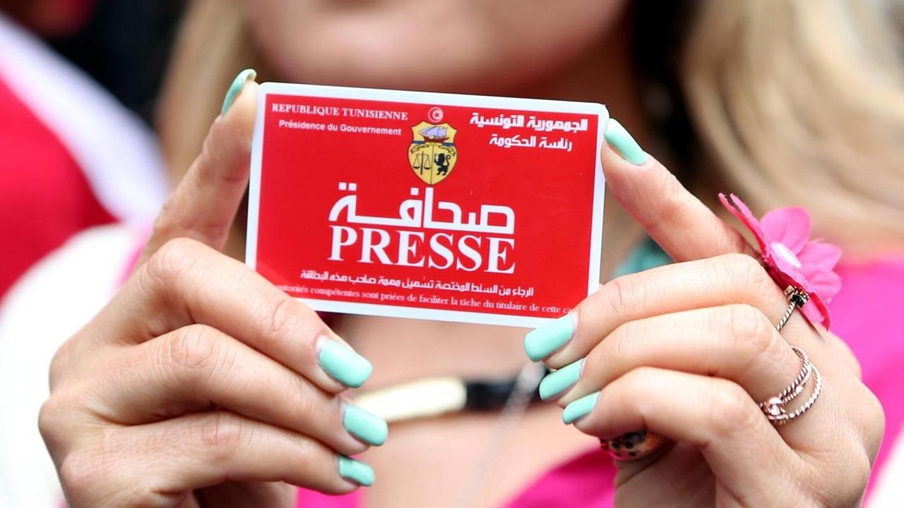 A Tunisian journalist poses with her Tunisian press card during a protest in front of the Interior Ministry to denounce the violations against journalists and media professionals in Tunis, Tunisia, 03 March 2014. The Arab Network for Human Rights Information (ANHRI) on 03 March condemned the growing violations against journalists and media professionals on the job by Tunisian authorities. A Tunisian journalist poses with her Tunisian press card during a protest in front of the Interior Ministry to denounce the violations against journalists and media professionals in Tunis, Tunisia, 03 March 2014. The Arab Network for Human Rights Information (ANHRI) on 03 March condemned the growing violations against journalists and media professionals on the job by Tunisian authorities.