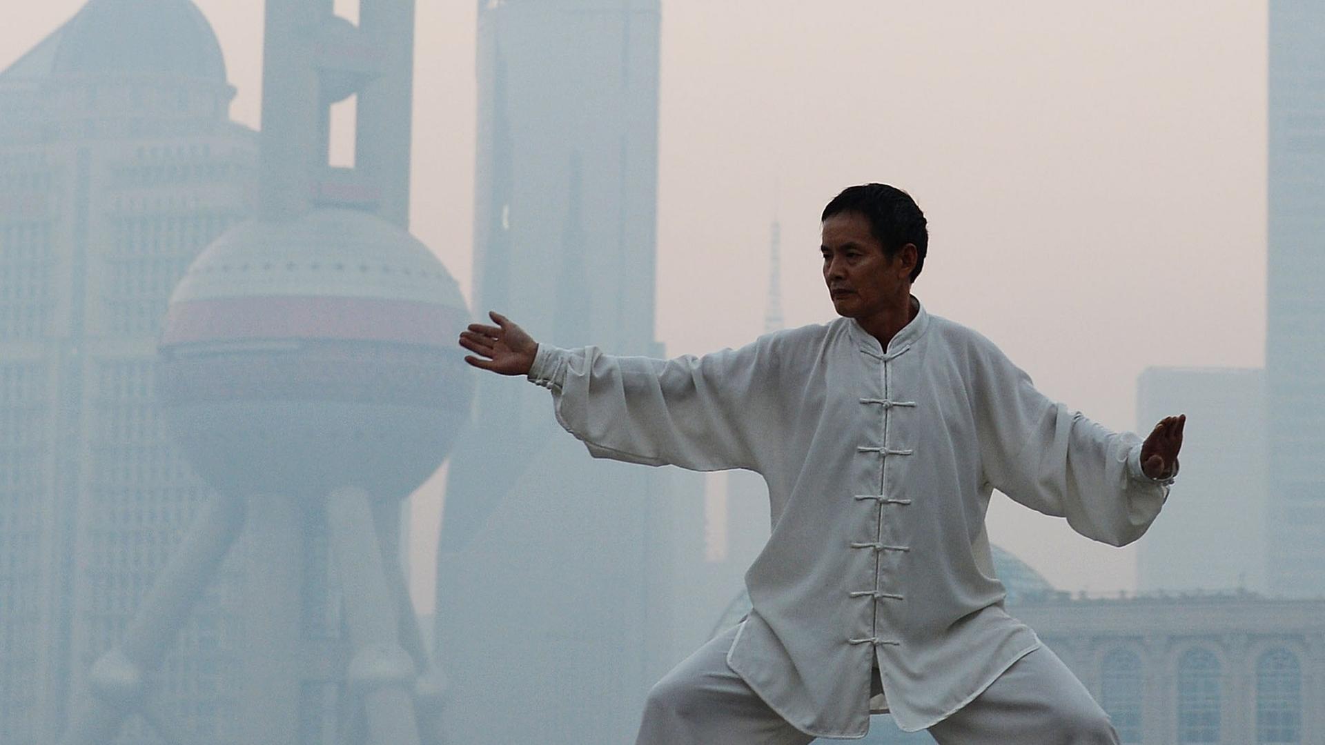 Ein Chinese übt Tai Chi in Shanghai, wo Smog herrscht Ein Chinese übt Tai Chi in Shanghai, wo Smog herrscht