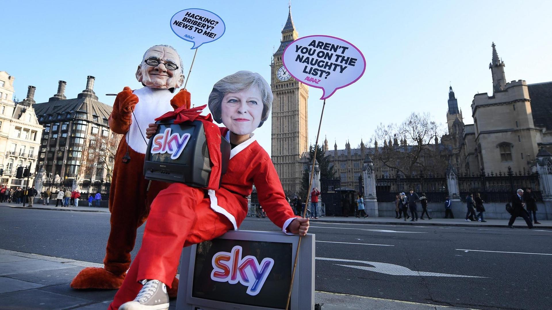 epa05683365 Campaigners dressed as Prime Minister Theresa May (R) and media mogul Rupert Murdoch (L) protest outside parliament in London, Britain, 20 December 2016. Campaigners protested against Murdoch's takeover bid for Sky. The action outside parliament comes as parliament considers whether to wave through Murdoch's Sky bid or to refer it to an official watchdog to look at whether Murdoch already owns too much British media. EPA/ANDY RAIN | epa05683365 Campaigners dressed as Prime Minister Theresa May (R) and media mogul Rupert Murdoch (L) protest outside parliament in London, Britain, 20 December 2016. Campaigners protested against Murdoch's takeover bid for Sky. The action outside parliament comes as parliament considers whether to wave through Murdoch's Sky bid or to refer it to an official watchdog to look at whether Murdoch already owns too much British media. EPA/ANDY RAIN |