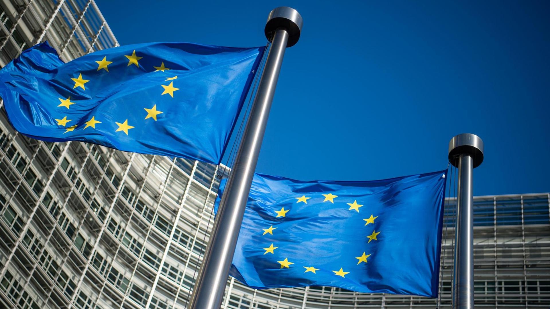 Flaggen der Europäischen Union wehen im Wind vor dem Berlaymont-Gebäude, dem Sitz der Europäischen Kommission. Flaggen der Europäischen Union wehen im Wind vor dem Berlaymont-Gebäude, dem Sitz der Europäischen Kommission.