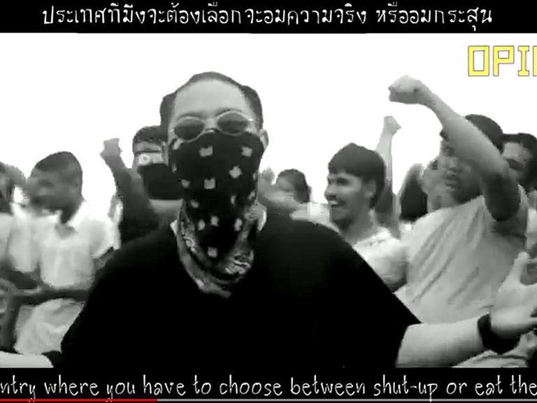 Screenshot aus dem Viode "Rap against dictatorship": ein junger Mann rappt vor einer Menschenmenge.