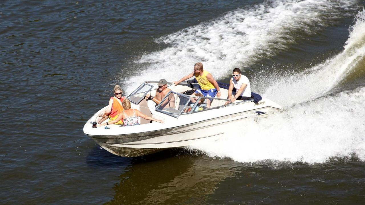 Ein Sportboot schießt übers Wasser. Ein Sportboot schießt übers Wasser.