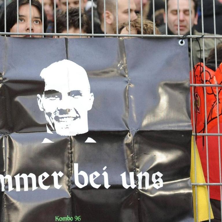 Fußballfans von Hannover 96 gedenken ihres früheren Torwarts Robert Enke mit einem Plakat. 