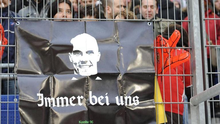 Fußballfans von Hannover 96 gedenken ihres früheren Torwarts Robert Enke mit einem Plakat. 