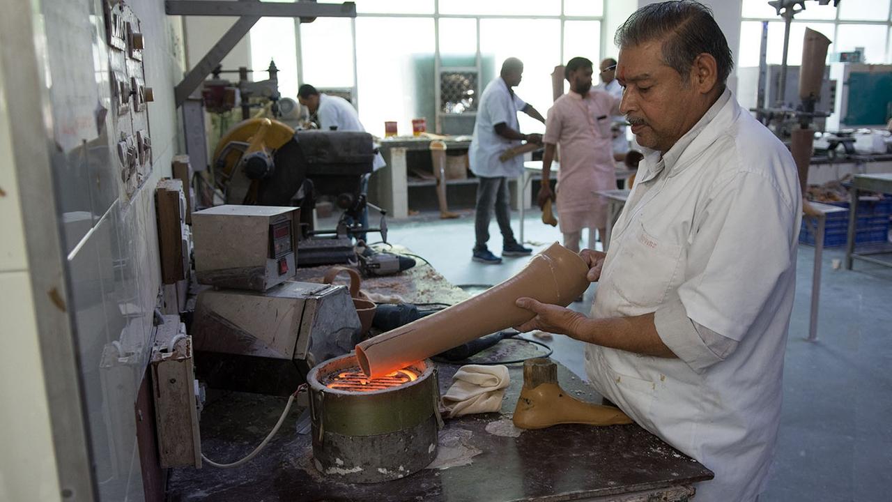 Ein Mitarbeiter verwandelt bei Jaipur Foot ein Wasserrohr zu einer Prothese
