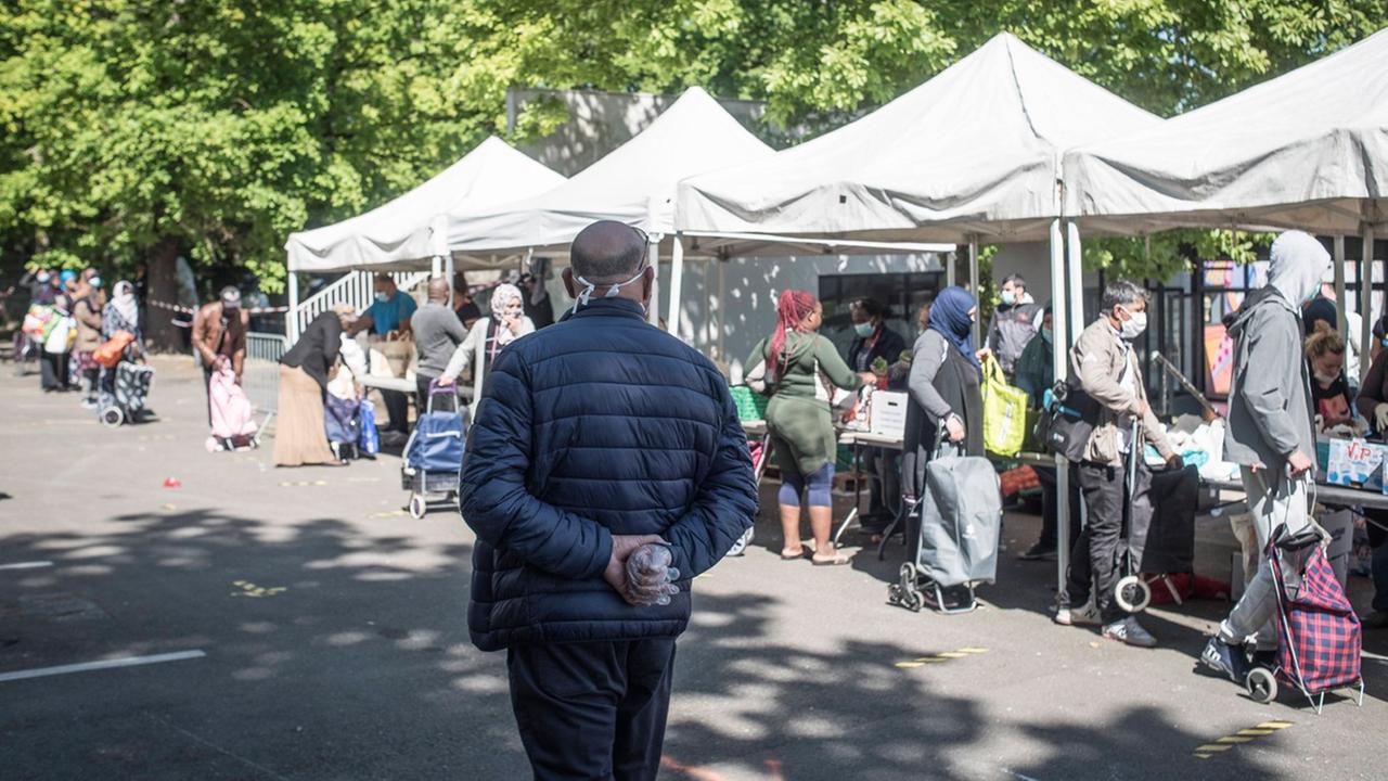 An mehreren Ständen wird Essen an Menschen ausgegeben. An mehreren Ständen wird Essen an Menschen ausgegeben.