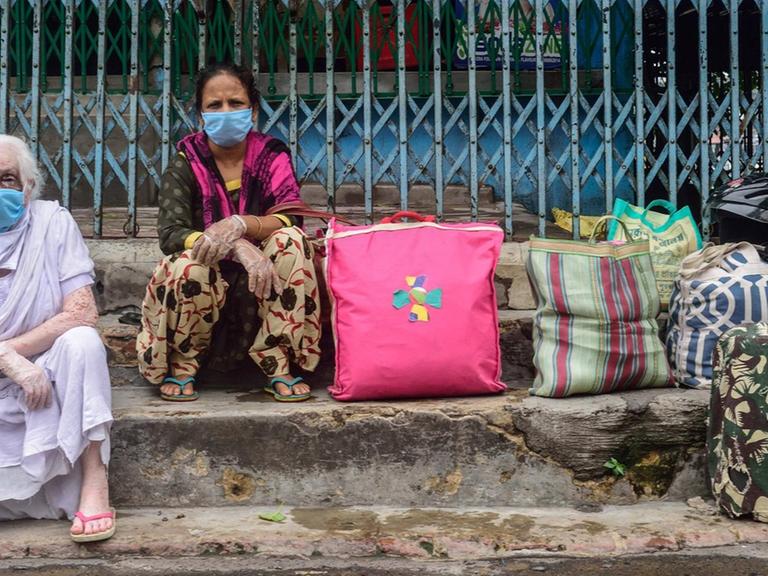 July 23, 2020, Kolkata, India: Women wearing face masks are seen stranded in Howrah station due to the unavailability of public transport during the two day a week lockdown in Kolkata..West Bengal government decided to impose a week lockdown in the state to curb the rise of the Coronavirus COVID-19 disease. Only persons in emergency services and patients have the permission to travel or make movements. Kolkata India - ZUMAs197 20200723_zaa_s197_054 Copyright: xSumitxSanyalx