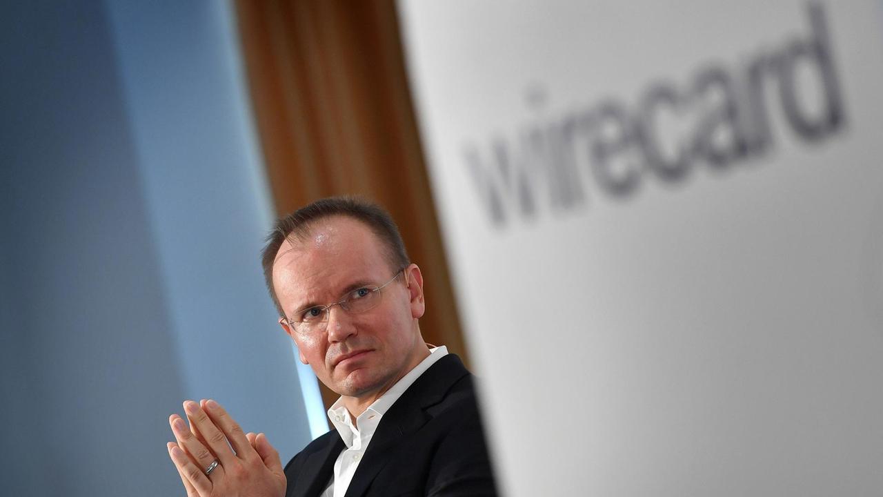 Ex-Wirecard-Vorstandsvorsitzender Markus Braun und das Logo des Unternehmens 