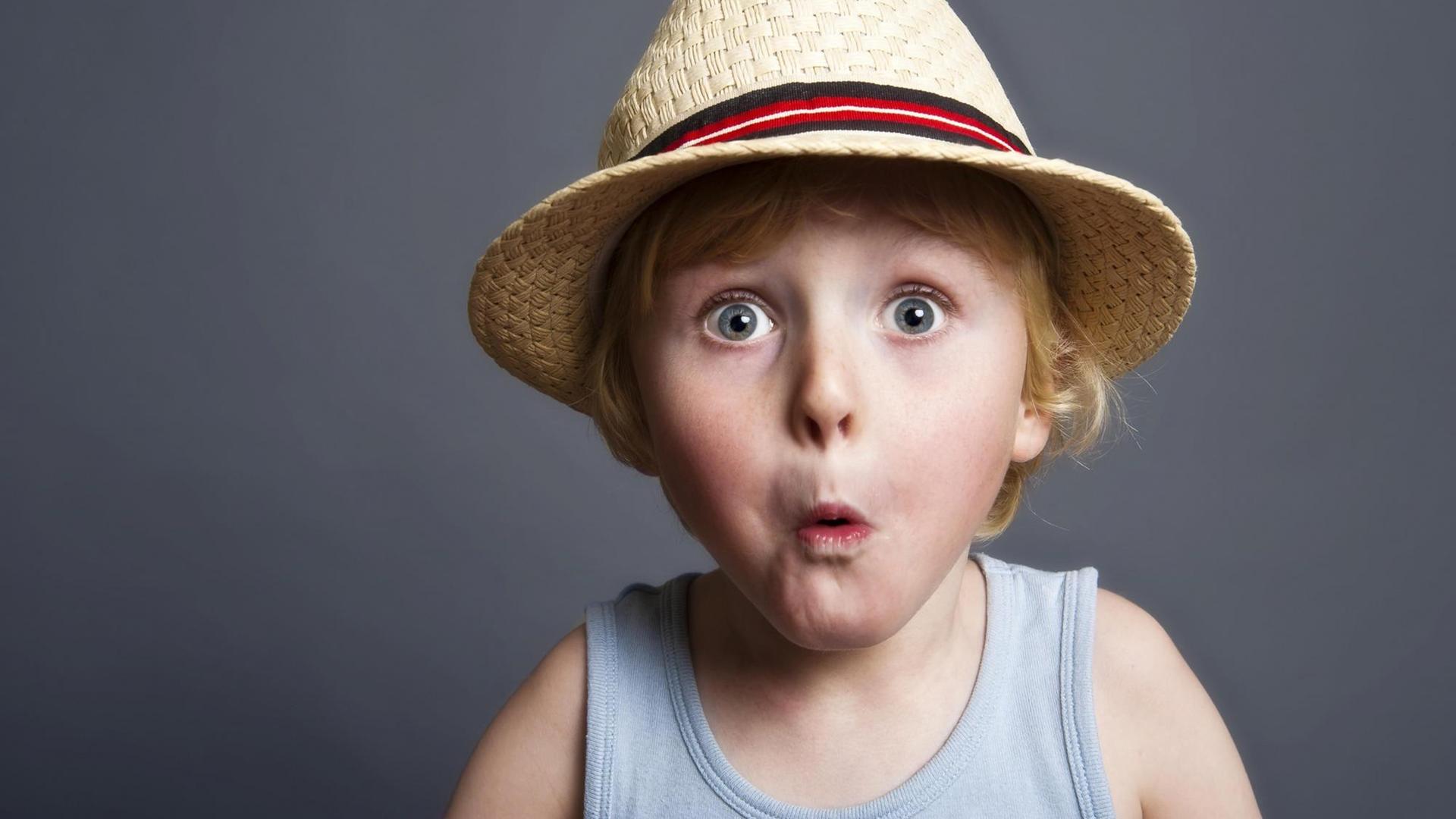 Fünfjähriger Junge mit Hut schaut mit erstauntem Blick in die Kamera. Fünfjähriger Junge mit Hut schaut mit erstauntem Blick in die Kamera.