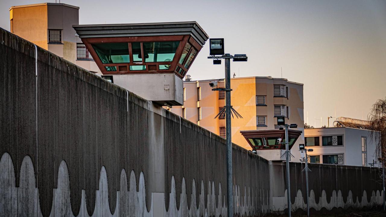 Eine lange Mauer mit Stacheldraht und Wachtürmen. Eine lange Mauer mit Stacheldraht und Wachtürmen.