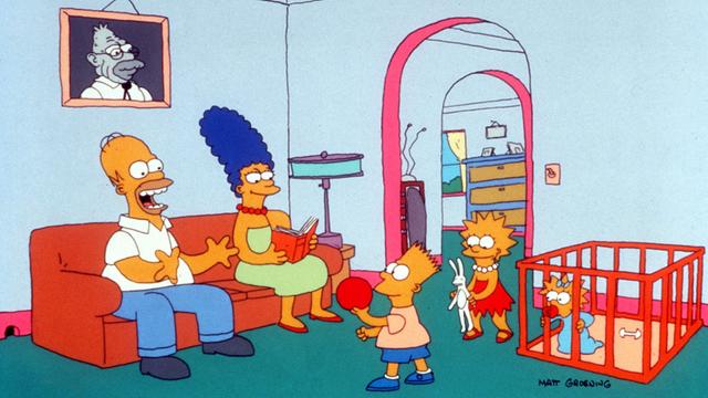 Die Simpson-Familie im Wohnzimmer: (l-r) Familienvater Homer Simpson, daneben auf dem Sofa seine Frau Marge, Bart, der Stammhalter der Familie, mit seiner intelligenten Schwester Lisa und das Nesthäkchen Maggie im Laufstall. Aufnahme von 1991.