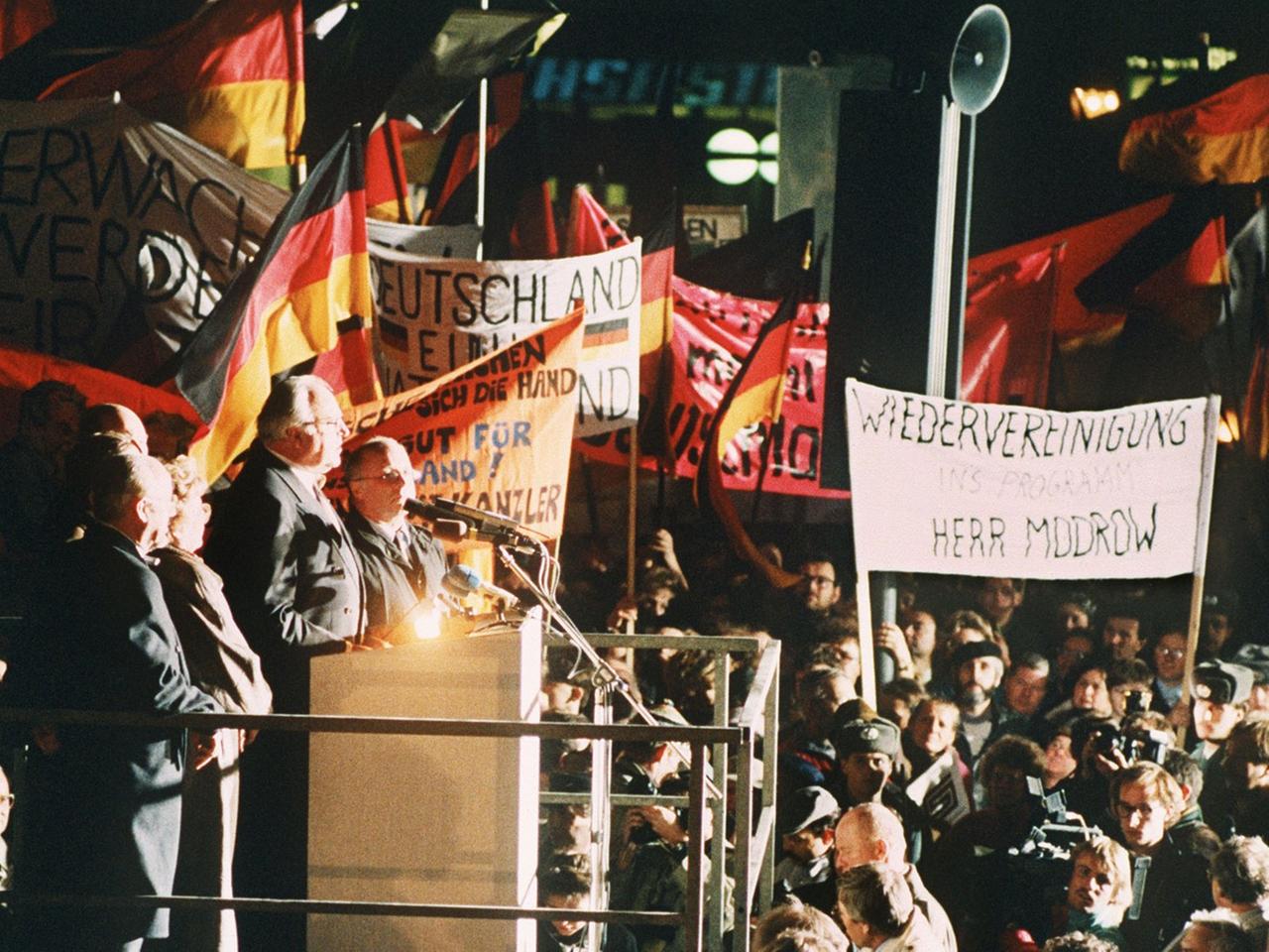 Bundeskanzler Helmut Kohl spricht am Abend des 19. Dezember 1989 zu der riesigen Menschenmenge, die sich anlässlich seines Besuches eingefunden hat. Kohl hielt sich zu einem zweitägigen Besuch in der sächsischen Stadt auf und wurde an beiden Tagen von der DDR-Bevölkerung stürmisch gefeiert.