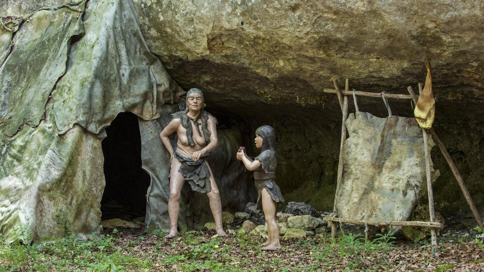Eine Darstellung einer Neandertal-Mutter und ihrer Tochter vor ihrer Hütte. Eine Darstellung einer Neandertal-Mutter und ihrer Tochter vor ihrer Hütte.