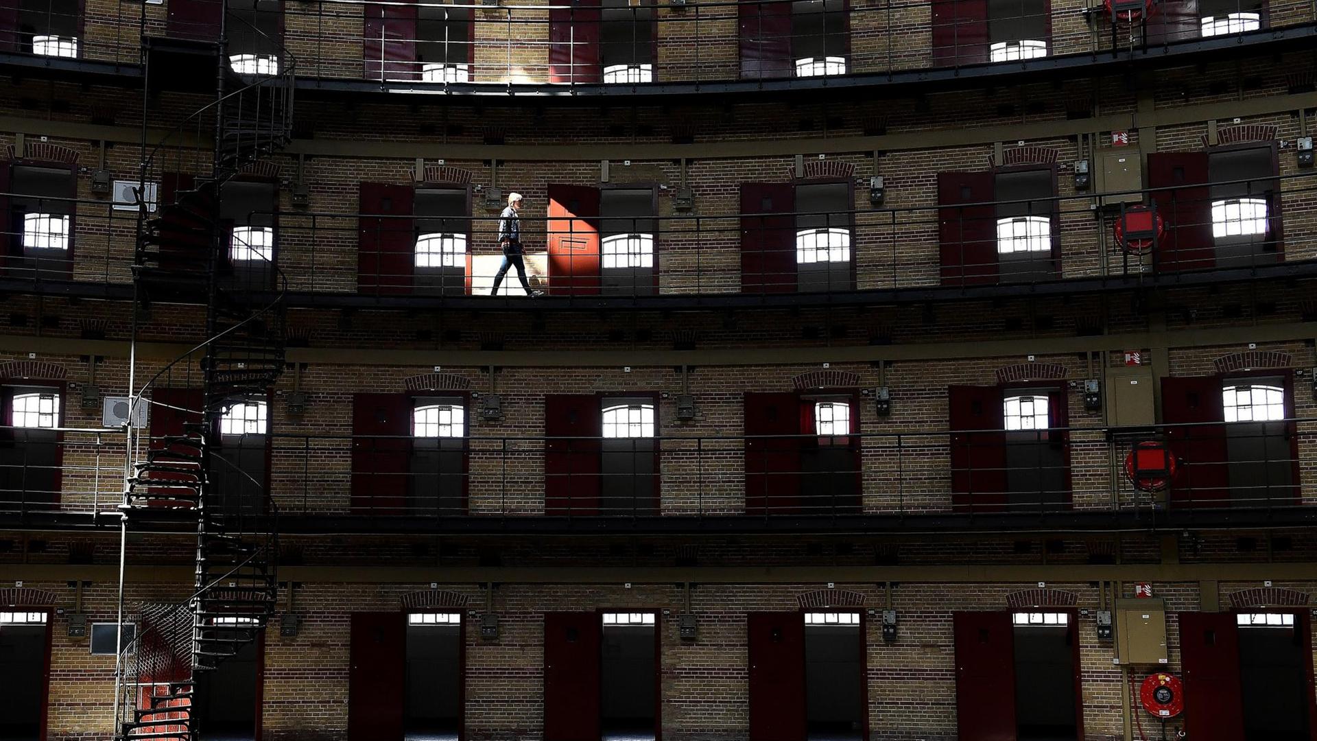 Eine Frau geht durch das Boschpoort-Gefängnis, ein kuppelförmiges Gefängnis in Breda, das nach einem Rückgang der Inhaftierungen in niederländischen Gefängnissen in den letzten 20 Jahren in ein Büro und einen Unterhaltungsort umgewandelt wurde. Eine Frau geht durch das Boschpoort-Gefängnis, ein kuppelförmiges Gefängnis in Breda, das nach einem Rückgang der Inhaftierungen in niederländischen Gefängnissen in den letzten 20 Jahren in ein Büro und einen Unterhaltungsort umgewandelt wurde.