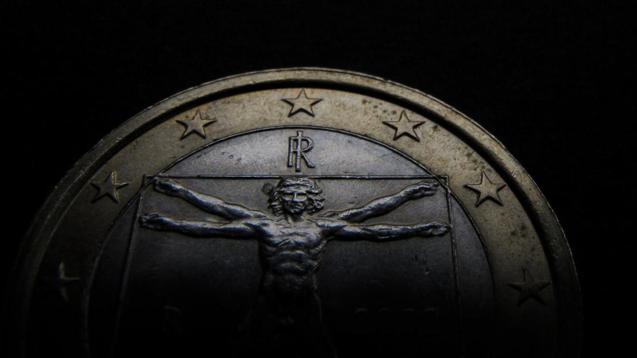 Obere Hälfte einer italienischen Ein-Euro-Münze vor schwarzem Hintergrund.