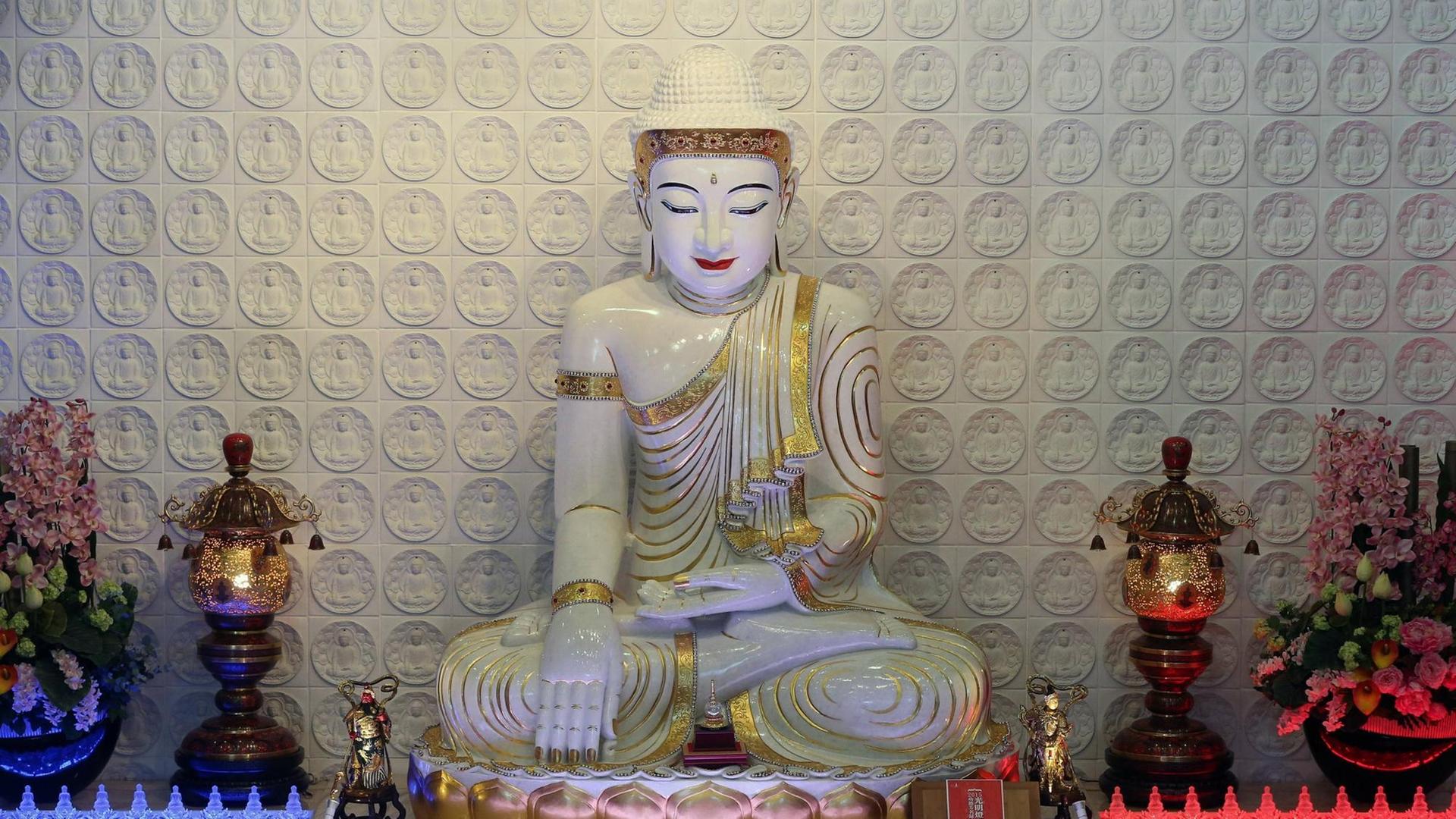 Buddha mit Abhaya Mudra, einer Geste, bei der Buddhas linke Hand nach oben geöffnet auf dem Schoß liegt, während die Fingerspitzen seiner rechten Hand den Boden berühren. Die Statue befindet sich in dem Fo Guang Shan Tempel in Bussy-Saint-Georges, Frankreich. Buddha mit Abhaya Mudra, einer Geste, bei der Buddhas linke Hand nach oben geöffnet auf dem Schoß liegt, während die Fingerspitzen seiner rechten Hand den Boden berühren. Die Statue befindet sich in dem Fo Guang Shan Tempel in Bussy-Saint-Georges, Frankreich.