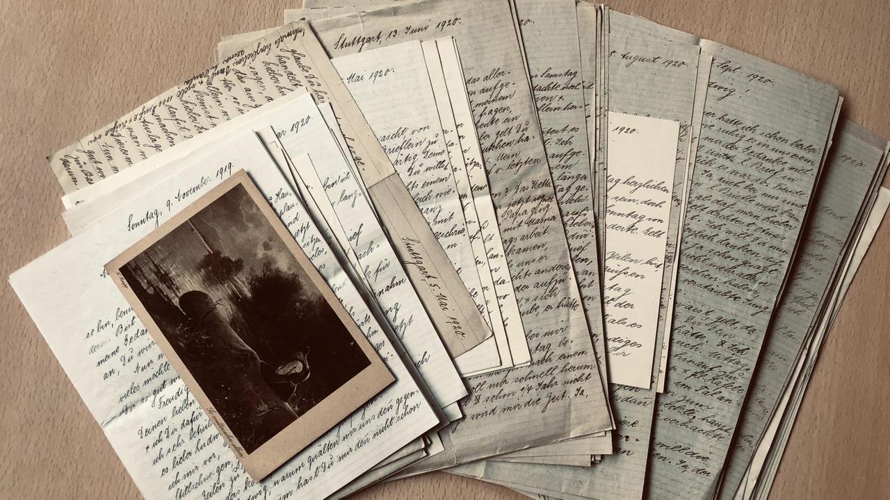 Ein augefächerter Stapel von Briefen und Fotos liegen auf einem Tisch Ein augefächerter Stapel von Briefen und Fotos liegen auf einem Tisch