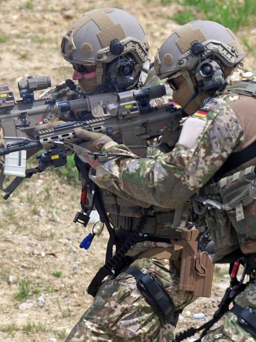 Zwei Soldaten des Kommandos Spezialkräfte in Kampfuniform und mit Waffen