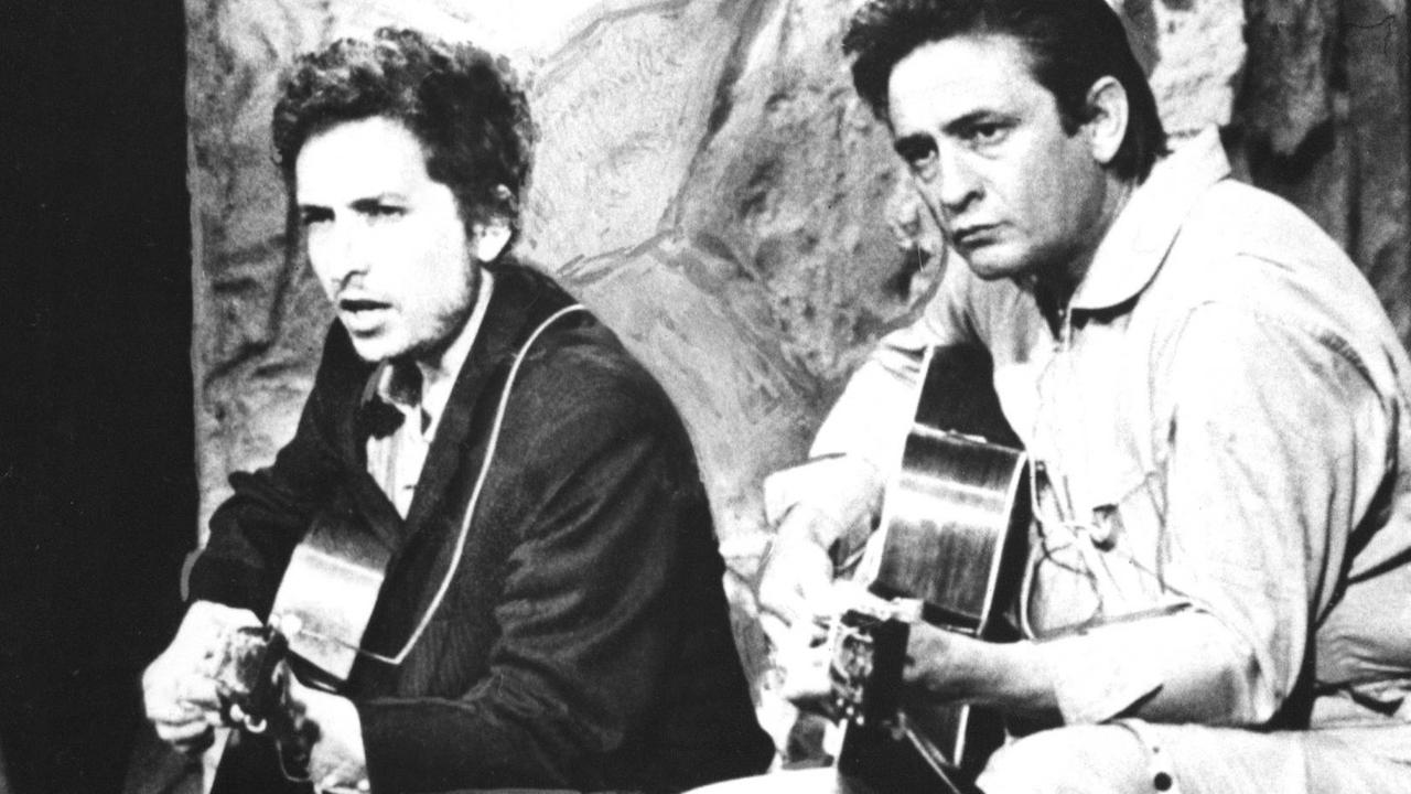 Johnny Cash und Bob Dylan spielen auf ihren Gitarren zusammen. Johnny Cash und Bob Dylan spielen auf ihren Gitarren zusammen.