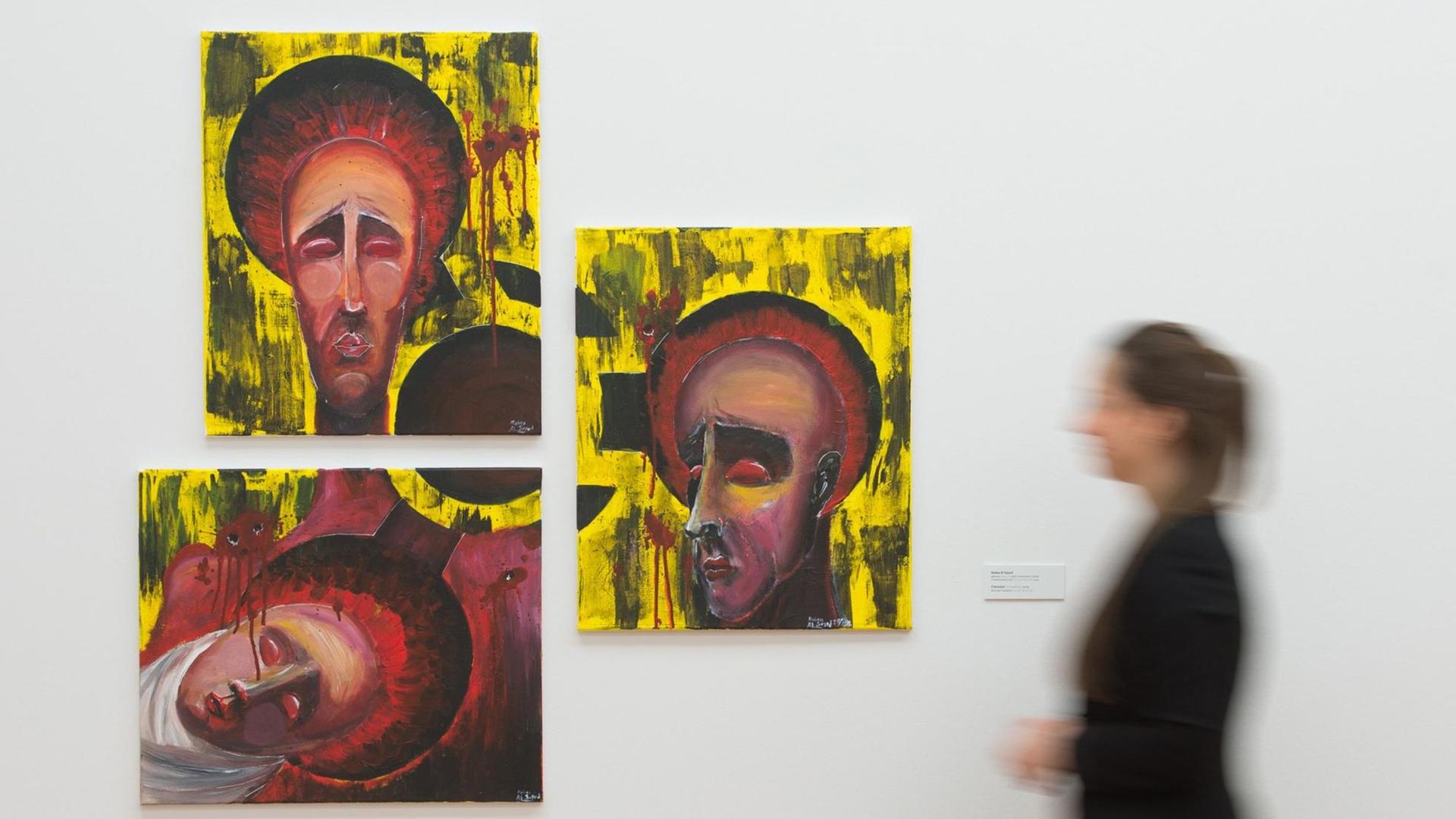 Eine Frau geht am 31.03.2016 in der Ausstellung «Wir We Nahnu - Auf der Flucht» in der Städtischen Galerie Dresden in Dresden (Sachsen) vor dem Kunstwerk "Chemical" des syrischen Künstlers Rabea Al Sayed entlang. Die Ausstellung zeigt bis zum 24. April 58 Werke - Gemälde, Zeichnungen, Holzschnitte, Fotos, ein Video, eine Skulptur und politische Cartoons - von Künstlern und kunstaffinen Laien unter Flüchtlingen und Migranten. Eine Frau geht am 31.03.2016 in der Ausstellung «Wir We Nahnu - Auf der Flucht» in der Städtischen Galerie Dresden in Dresden (Sachsen) vor dem Kunstwerk "Chemical" des syrischen Künstlers Rabea Al Sayed entlang. Die Ausstellung zeigt bis zum 24. April 58 Werke - Gemälde, Zeichnungen, Holzschnitte, Fotos, ein Video, eine Skulptur und politische Cartoons - von Künstlern und kunstaffinen Laien unter Flüchtlingen und Migranten.