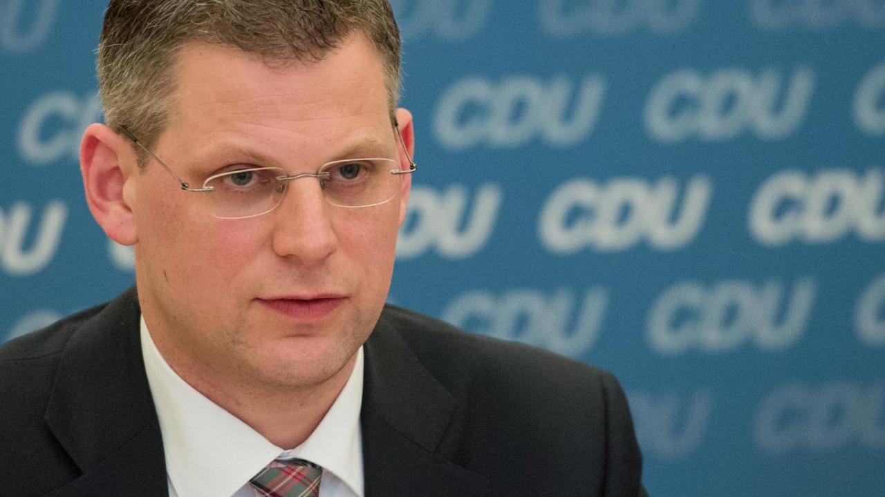 Porträt von Christoph de Vries vor einer blauen Wand mit CDU-Schriftzügen. Porträt von Christoph de Vries vor einer blauen Wand mit CDU-Schriftzügen.