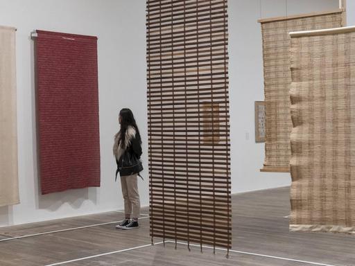 October 9, 2018 - London, UK - Eine Museumsbesucherin schaut Textilarbeiten der deutschen Künstlerin Anni Albers aus den Jahren 1935 und 1949 in einer Ausstellung in der Tate Modern in London an.