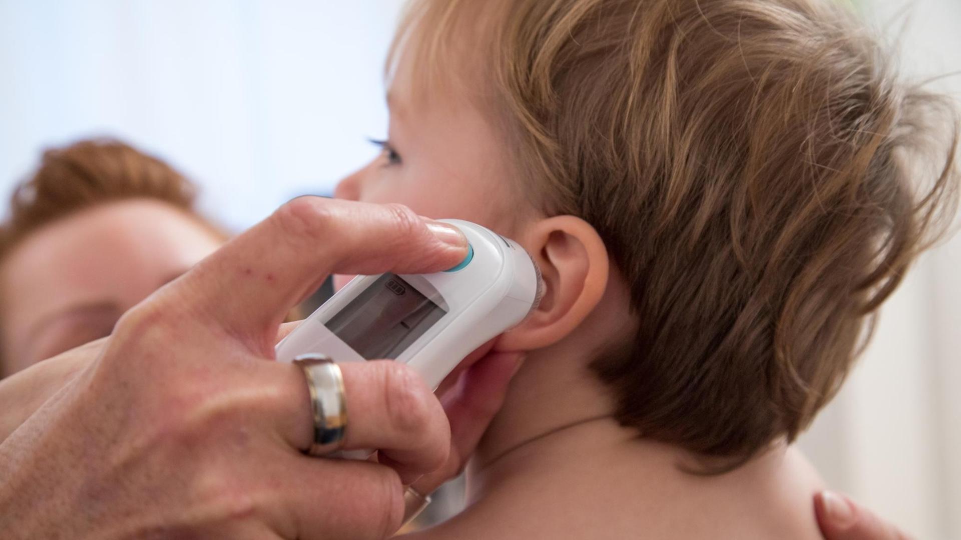 Eine Kinderaerztin untersucht einen kleinen Jungen (gestellte Szene). Eine Kinderaerztin untersucht einen kleinen Jungen (gestellte Szene).