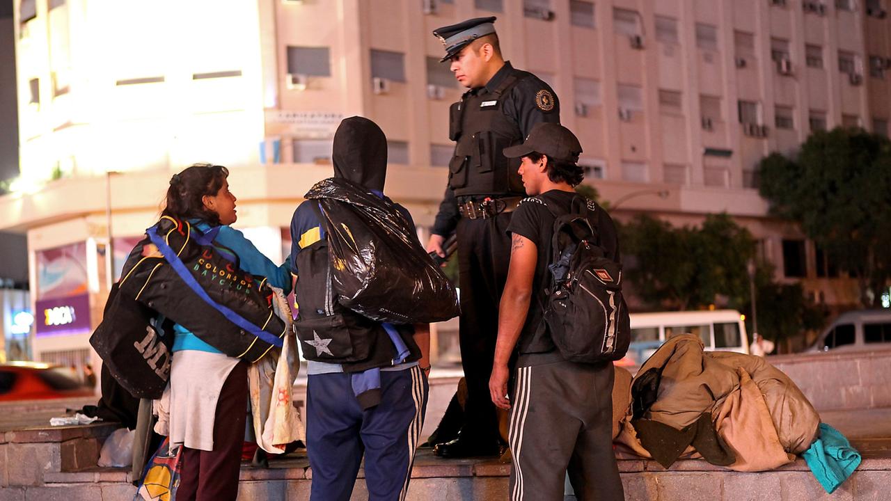 Die Innenstadt von Buenos Aires bei Nacht mit ihren ganz eigenen Bewohnern. - Ein Polizist im Gespräch mit Obdachlosen. Die Innenstadt von Buenos Aires bei Nacht mit ihren ganz eigenen Bewohnern. - Ein Polizist im Gespräch mit Obdachlosen.