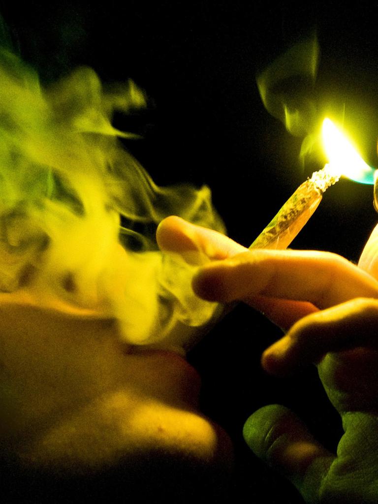 Ein Jugendlicher raucht einen Joint.
