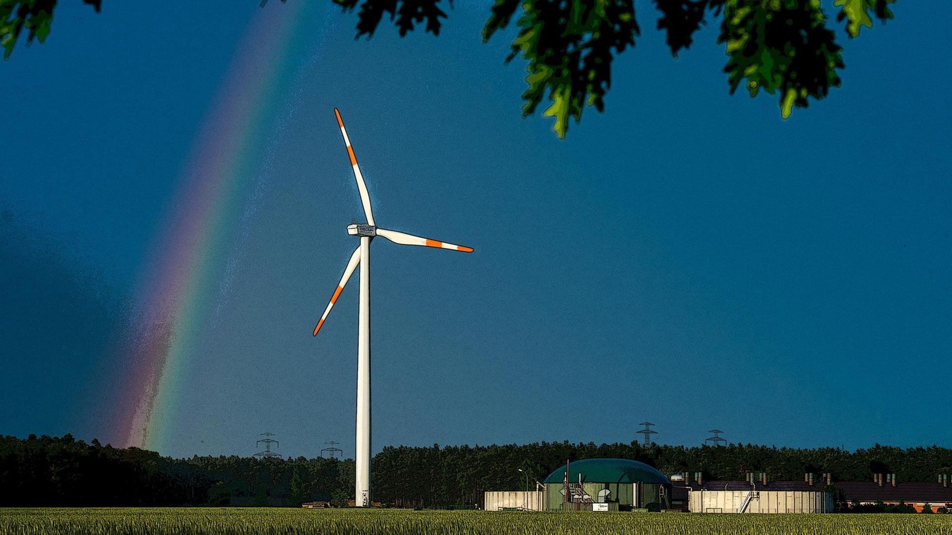 Ein Regenbogen leuchtet vor dunklen Gewitterwolken hinter einem Windrad im Landkreis Spree-Neiße nahe Peitz (Brandenburg). Ein Regenbogen leuchtet vor dunklen Gewitterwolken hinter einem Windrad im Landkreis Spree-Neiße nahe Peitz (Brandenburg).