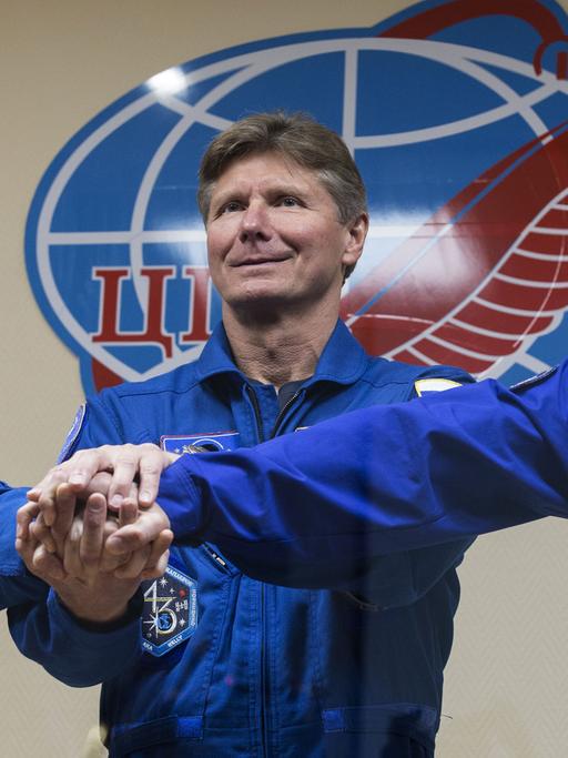 US austronaut Scott Kelly (NASA) and Russian austronauts Gennady Padalka, Mikhail Kornienko (RSA), from left, members of the main crew of Expedition 43/44 to the International Space Station, pose for a group photo at a press conference ahead of the start of a one-year mission.