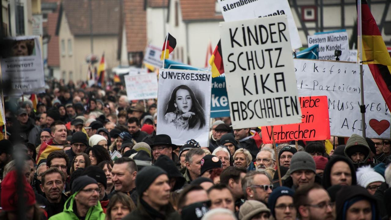 Hunderte Teilnehmer ziehen durch die Straße, einige halten Transparente und Schilder hoch, auf denen die Flüchtlingspolitik der Regierung kritisiert wird. Hunderte Teilnehmer ziehen durch die Straße, einige halten Transparente und Schilder hoch, auf denen die Flüchtlingspolitik der Regierung kritisiert wird.