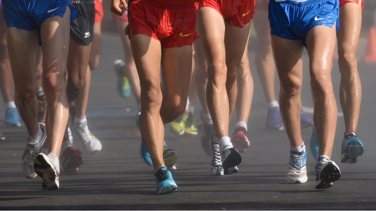Die Beine von männlichen Athleten, die gerade 20 Kilometer Gehen absolvieren. Die Beine von männlichen Athleten, die gerade 20 Kilometer Gehen absolvieren.