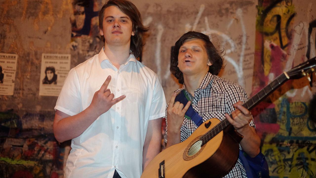 Der Schauspielstudent Kostja (r) und sein Freund Wasja machen vor der Zoj-Wand am Arbat im historischen Zentrum Moskaus Musik. Der Schauspielstudent Kostja (r) und sein Freund Wasja machen vor der Zoj-Wand am Arbat im historischen Zentrum Moskaus Musik.