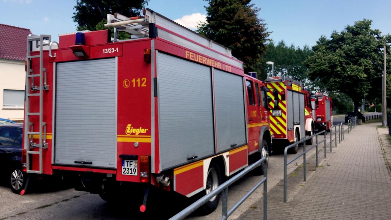 Drei Feuerwehr LKW fahren eine Straße entlang. Drei Feuerwehr LKW fahren eine Straße entlang.