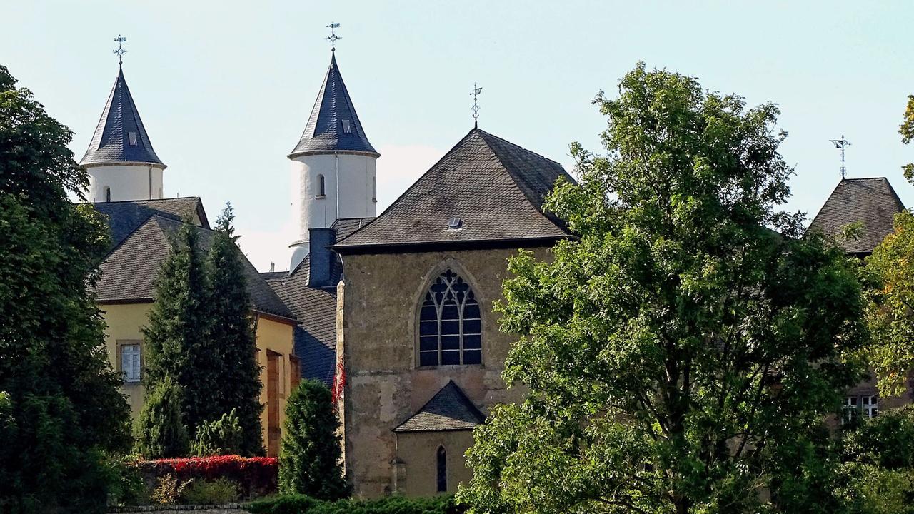 Blick auf das Kloster Steinfeld in der Eifel von einer nahe gelegenen Wiese aus Blick auf das Kloster Steinfeld in der Eifel von einer nahe gelegenen Wiese aus