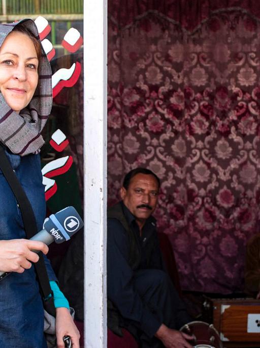 Silke Diettrich ist in Kabul mit einem Mikrofon in der Hand unterwegs.