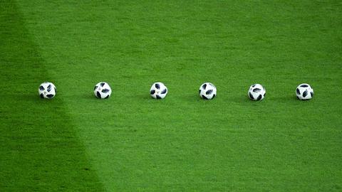 Sechs Fußbälle liegen beim Testspiel Deutschland - Brasilien im Berliner Olympiastadion am 27.03.2018 in einer Reihe auf dem Rasen.