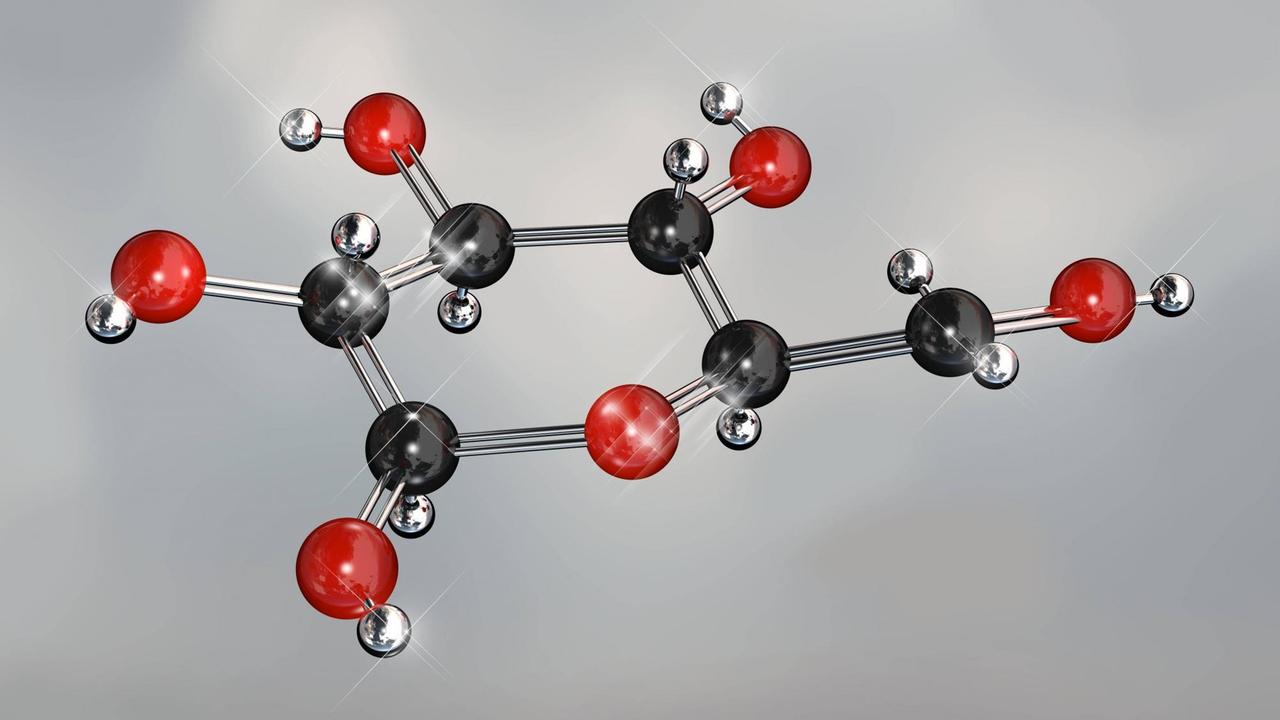 Ein Modell eines Glucose-Moleküls: schwarze und rote Kugeln an einem silbernen Gestänge Ein Modell eines Glucose-Moleküls: schwarze und rote Kugeln an einem silbernen Gestänge